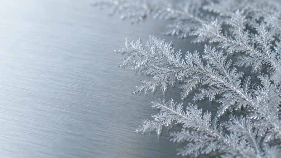 AI-generated macro study of frost crystals on brushed steel